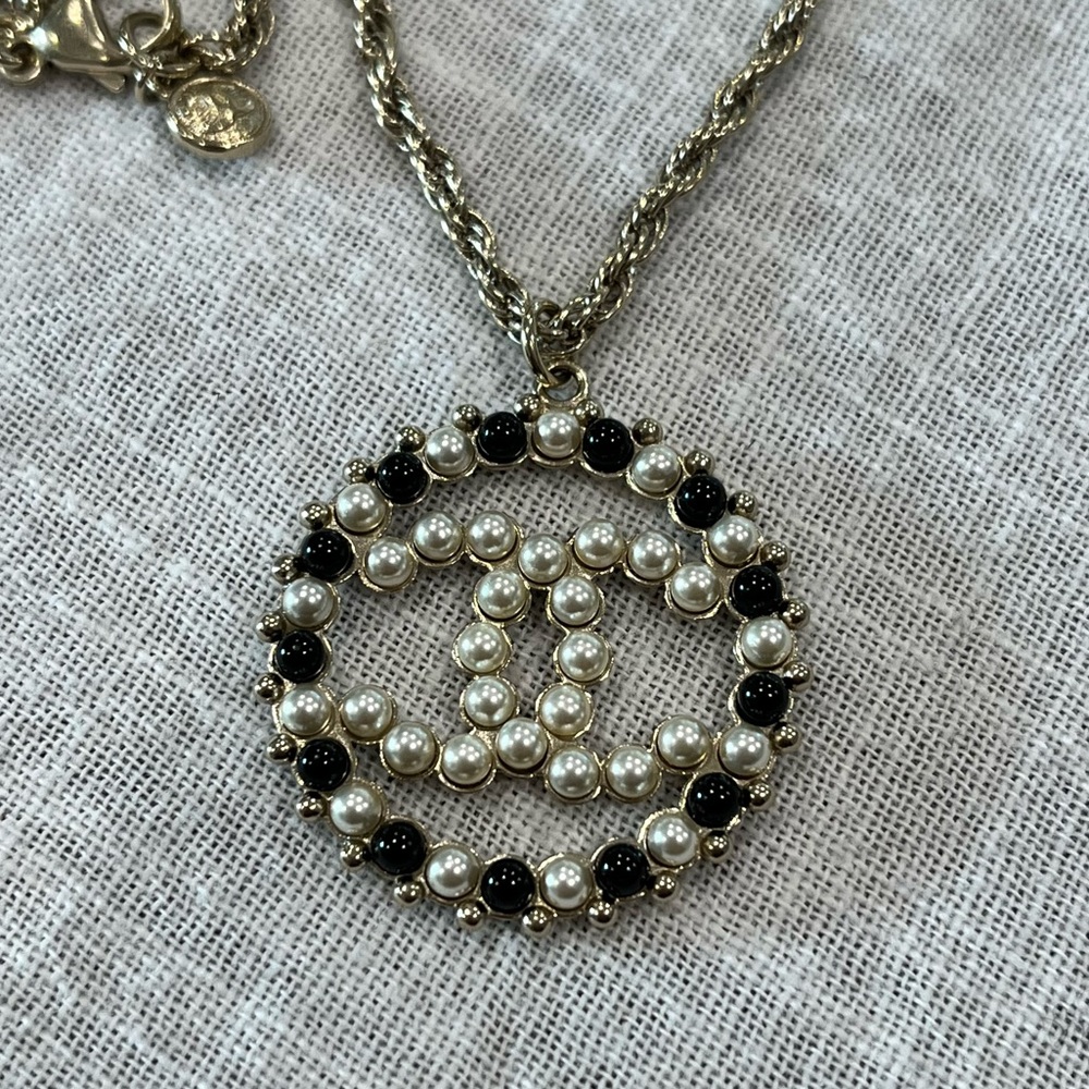 Authentic Chanel gold pearl CC pendant necklace.  Used new condition. No flaws.